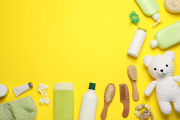 Flat lay composition with baby cosmetic products on yellow background, space for text