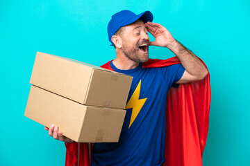 Super Hero delivery man isolated on blue background smiling a lot