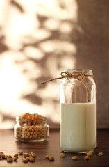 fermented milk product kefir in a glass jar with pine nuts on a beige background