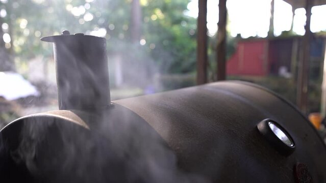 Close up of smoking backyard barbeque cooking a delicious authentic American meal