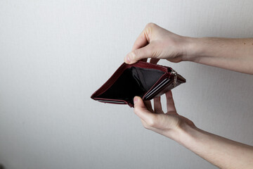 girl holding an empty purse. no money. lack of work and hard life.