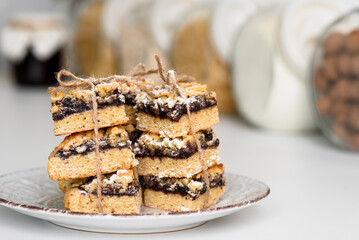 White plate with dessert in focus in the foreground. Tasty breakfast. Banks are out of focus in the background.