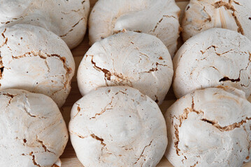 Meringue cracked. Round chocolate meringue. Meringue on the dock. Meringue on a white background.