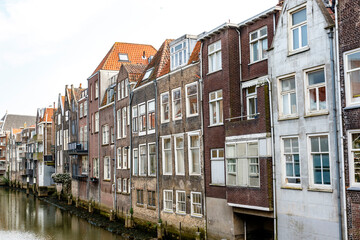 Fototapeta na wymiar Canal with old Dutch houses in Dordrecht, Zuid-Holland, The Netherlands, Europe