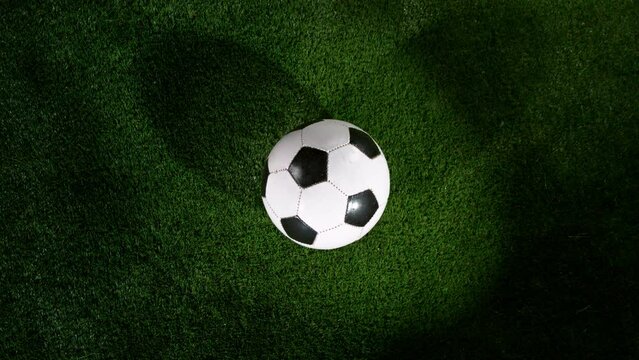Close-up of Rotating Soccer Ball on Football Field, Rainy Weather. Super Slow Motion at 1000 fps. Filmed on High Speed Cinematic Camera.