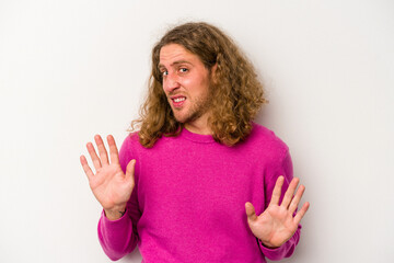 Young caucasian man isolated on white background rejecting someone showing a gesture of disgust.