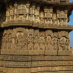 A Close up picture of beautiful Stone carvings of Hindu deities on the walls of a Shiva temple at Hosaholalu in Karnataka, India.
