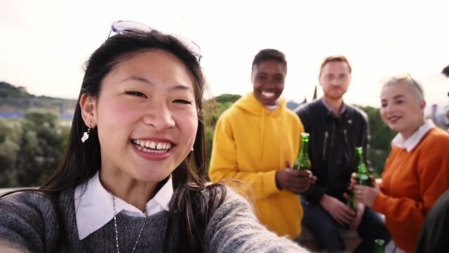 Smiling selfie of cheerful group of young people. Happy friends video call excited having fun. Interracial boys and girls taking picture looking at camera smart mobile phone. Enjoying vacations
