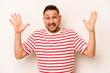 Young hispanic man isolated on white background screaming to the sky, looking up, frustrated.
