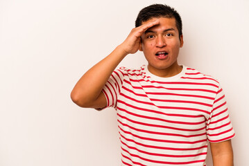 Young hispanic man isolated on white background shouts loud, keeps eyes opened and hands tense.