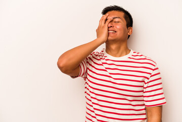 Young hispanic man isolated on white background laughing happy, carefree, natural emotion.