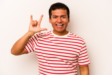 Young hispanic man isolated on white background showing a horns gesture as a revolution concept.