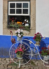 Fototapeta na wymiar Colorful decoration with metal decorative bike, flamingo, and old window