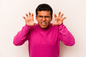 Young hispanic man isolated on white background showing claws imitating a cat, aggressive gesture.