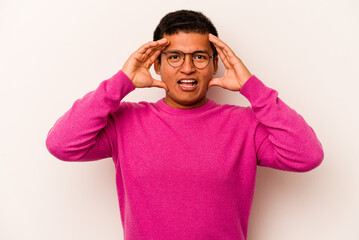Naklejka premium Young hispanic man isolated on white background receiving a pleasant surprise, excited and raising hands.