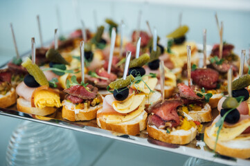 A wide variety of snacks on the table for guests. Shrimp, boiled pork, various types of meat and other products