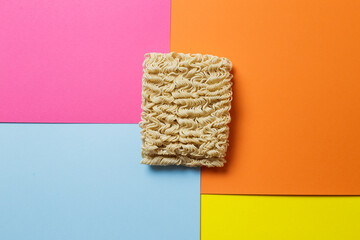 raw instant noodles on colorful background. - obrazy, fototapety, plakaty