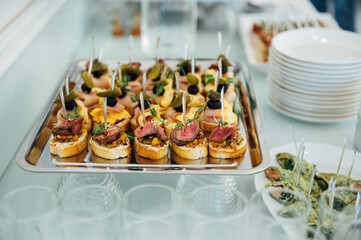 A wide variety of snacks on the table for guests. Shrimp, boiled pork, various types of meat and other products