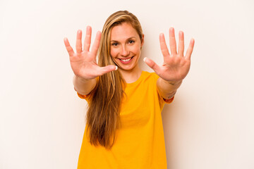 Young caucasian woman isolated on white background showing number ten with hands.