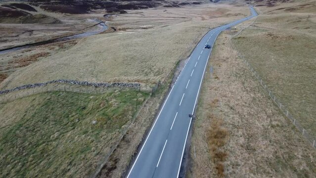 A sport car in Scotland highlands near Glenshee against a backdrop of wilderness