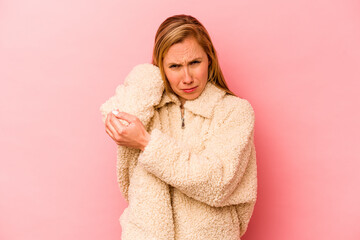 Young caucasian woman isolated on pink background having a neck pain due to stress, massaging and touching it with hand.