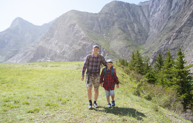 Fototapeta premium father and son hiking in the mountains