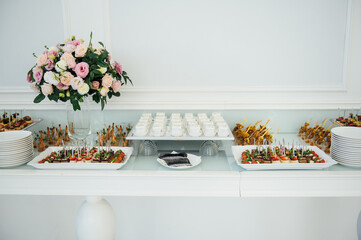 A wide variety of snacks on the table for guests. Shrimp, boiled pork, various types of meat and other products