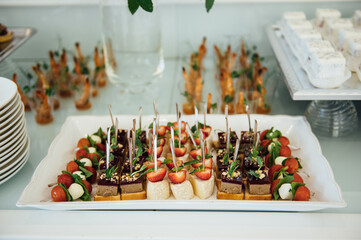 A wide variety of snacks on the table for guests. Shrimp, boiled pork, various types of meat and other products