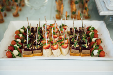 A wide variety of snacks on the table for guests. Shrimp, boiled pork, various types of meat and other products