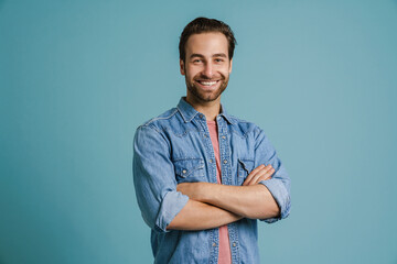 Young bristle man wearing shirt smiling while posing with arms crossed
