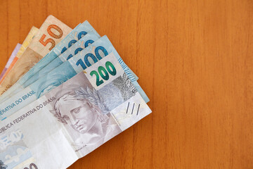Brazilian money banknotes on wooden surface