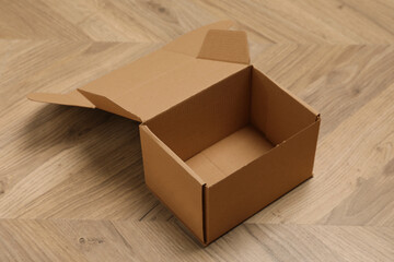 One empty open cardboard box on floor