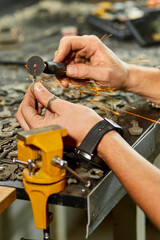 Locksmith in workshop makes new key, use grinding engraving machine