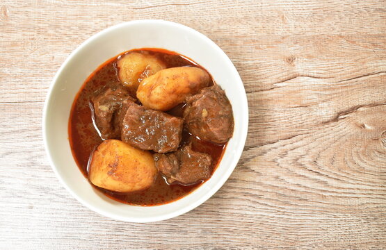 beef meat massaman curry with slice potato and onion in bowl
