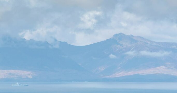 The Isle of Arran Mountains on the West Coast of Scotland in Late spring with rolling clouds and mist over goat fell giving a dramatic motion effect. From Fairlie Moor on the west coast.
