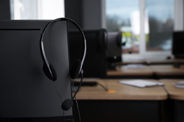 Obraz na płótnie Canvas Modern computer with headset in office. Hotline service