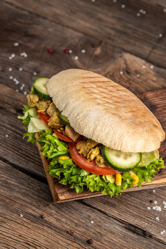 Grilled club sandwich panini with with crispy chicken and salad on cutting board. Turkish chicken doner sandwich. Fast food. vertical image. top view. place for text