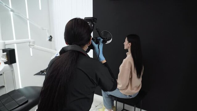 Dentist orthodontist is taking pictures of woman before treatment in dentistry Orthodontic treatment in dentistry dental prosthetics