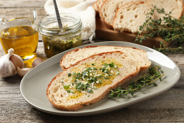 Tasty bruschettas with oil and garlic on wooden table