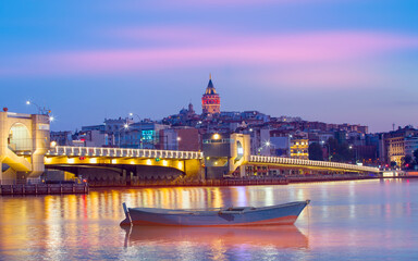 Galata Tower, Galata Bridge, Karakoy district and Golden Horn at morning with Closeup of wooden small boat floating on the sea - istanbul - Turkey