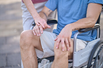 A close up picture of a man sitting in a wheel chair