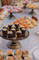Various desserts and cake on the buffet table at the wedding