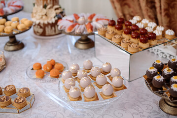 Various desserts and cake on the buffet table at the wedding
