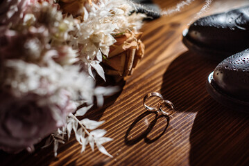 Grooms accessories for wedding, rings, shoes, bowtie and bouquets in the morning