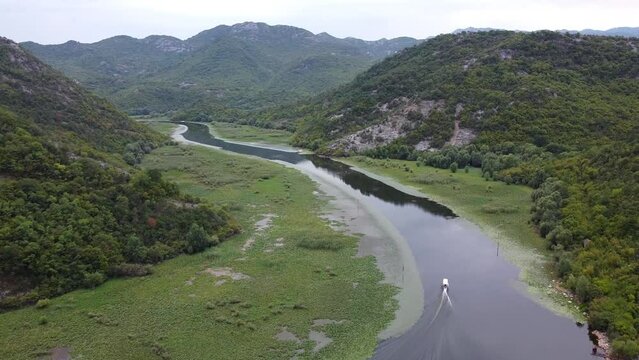 Boat Sails over Crnojevica River and Lake Skader at Pavlova Strana Viewpoint, Montenegro - Aerial Dolly