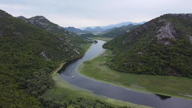 Boat Sails over Lake Skader and Crnojevica River at Pavlova Strana Viewpoint, Montenegro - Aerial
