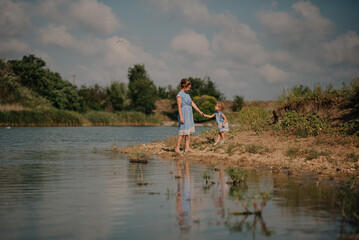Mother and daughter playing on the lake