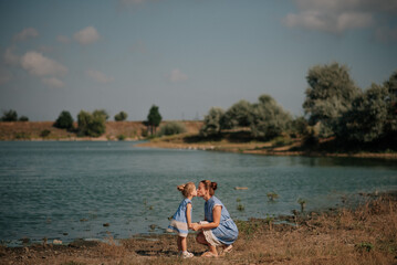 Mother and daughter playing on the lake