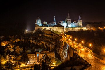Fototapeta na wymiar Night view of medieval half-ruined castle in Kamenetz-Podolsk, Ukraine