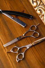 Barbershop tools on wooden background. Vintage tools of a barbershop on wood desk. Barber scissors and razor